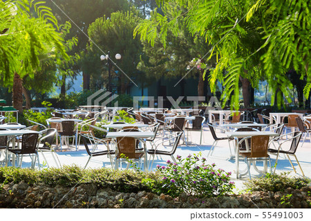 Empty tables of the summer restaurant of the hotel Empty tables of the summer restaurant of the hotel 55491003