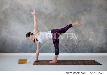 woman practicing yoga in twisted Half Moon 55491525