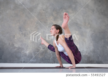 Woman doing handstand, variation of Firefly 55491527