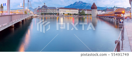 Lucerne. Panorama. The famous Chapel, Kapellbrucke bridge at dawn in night lighting. 55491749