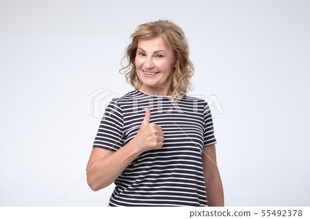 Happy mature european woman thumbs up Happy mature european woman thumbs up 55492378