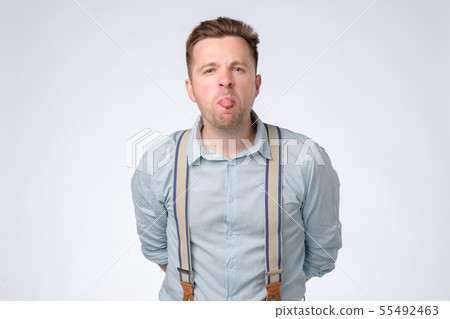 Young man shows tongue  55492463