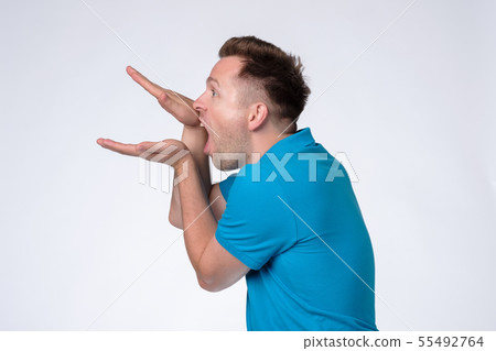Caucasian man in blue shirt making bla bla sign Caucasian man in blue shirt making bla bla sign 55492764