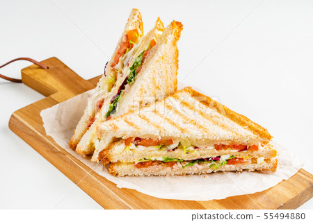 Sandwich with ham, cheese, tomatoes, lettuce, and toasted bread. Sandwich with ham, cheese, tomatoes, lettuce, and toasted bread. 55494880