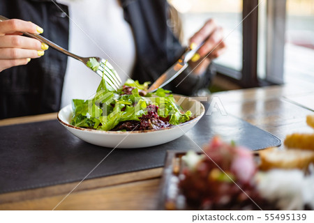 woman eating green healthy salad 55495139