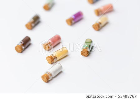 Cosmetics, makeup and beauty concept - Colourful eye shadow in small glass boxes on white background Cosmetics, makeup and beauty concept - Colourful eye shadow in small glass boxes on white background 55498767