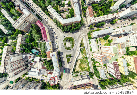 Aerial city view with crossroads and roads, houses, buildings, parks and parking lots. Sunny summer Aerial city view with crossroads and roads, houses, buildings, parks and parking lots. Sunny summer 55498984