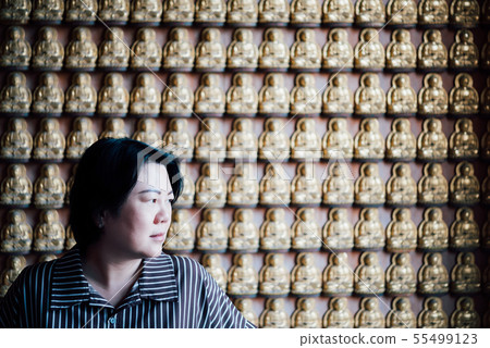 Woman at Wat Boromracha Kanchanapisek Anusorn Woman at Wat Boromracha Kanchanapisek Anusorn 55499123