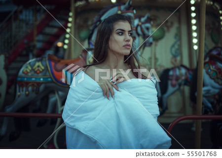 Sad young woman wrapped in a blanket near the Sad young woman wrapped in a blanket near the 55501768