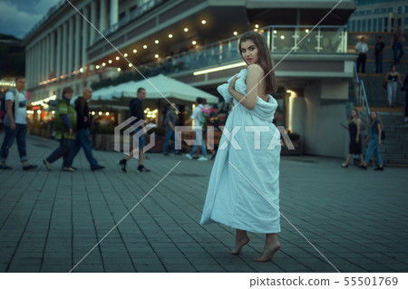 Portrait of a beautiful woman in a white blanket. Portrait of a beautiful woman in a white blanket. 55501769