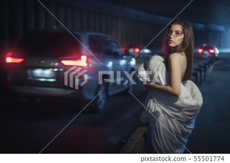 Woman wrapped herself in a blanket and stands by Woman wrapped herself in a blanket and stands by 55501774