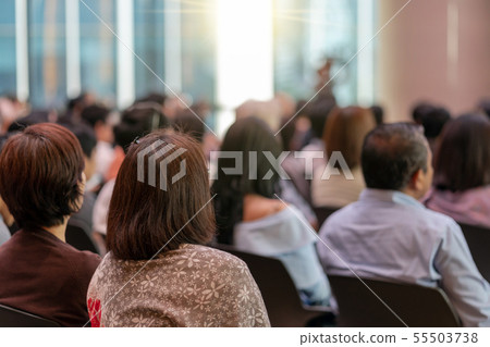 Rear view of Audience in the conference hall or seminar meeting which have Speakers are Brainstorming and talking on the stage, business and education about investment concept Rear view of Audience in the conference hall or seminar meeting which have Speakers are Brainstorming and talking on the stage, business and education about investment concept 55503738