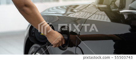 Banner of Closeup asian Technician hand is charging the electric car or EV in service center for maintainance, Eco-friendly alternative energy concept, cover and banners 55503743