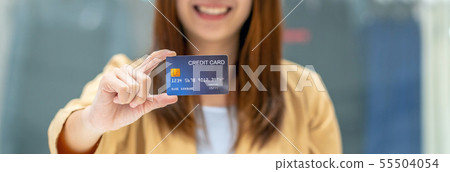 Banner of Asian woman holding and presenting the credit card for online shopping in department store over the clothes shop store, technology money wallet and online payment concept, credit card mockup Banner of Asian woman holding and presenting the credit card for online shopping in department store over the clothes shop store, technology money wallet and online payment concept, credit card mockup 55504054