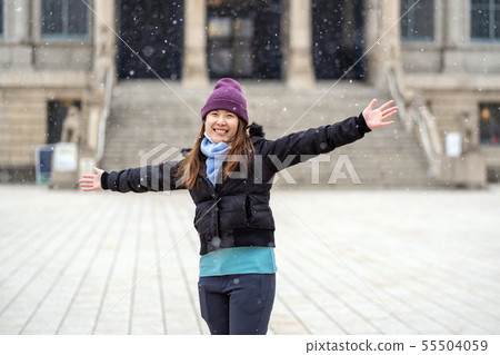 Asian Young woman playing the snow when Snow just fell, travel and excited concept, wool hat with scart and overcoat for winter season Asian Young woman playing the snow when Snow just fell, travel and excited concept, wool hat with scart and overcoat for winter season 55504059