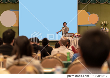 Closeup portrait of asian Speaker with casual suit on the stage over the presentation screen in the conference hall or seminar meeting, business and education concept Closeup portrait of asian Speaker with casual suit on the stage over the presentation screen in the conference hall or seminar meeting, business and education concept 55504067