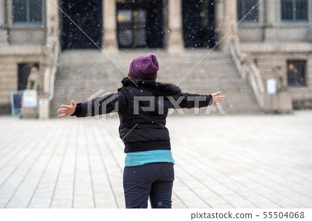 Back side of Asian Young woman playing the snow when Snow just fell, travel and excited concept, wool hat with scart and overcoat for winter season Back side of Asian Young woman playing the snow when Snow just fell, travel and excited concept, wool hat with scart and overcoat for winter season 55504068