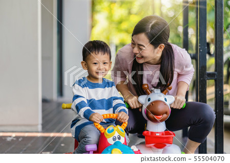 Asian single mom with son are playing with car toy together when living in modern house for Self learning or home school, Family and single mom concept, selective focus Asian single mom with son are playing with car toy together when living in modern house for Self learning or home school, Family and single mom concept, selective focus 55504070
