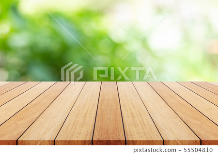 Empty dish on wooden table with green blur light background. For photo montage 55504810