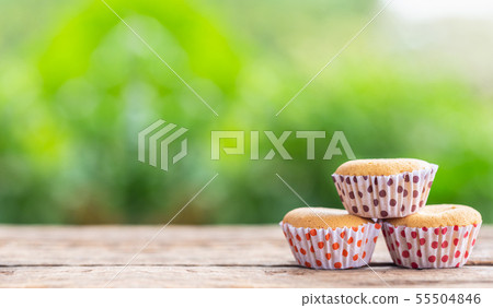 Ancient egg cakes in paper cup on wooden table with green nature light blur background Ancient egg cakes in paper cup on wooden table with green nature light blur background 55504846