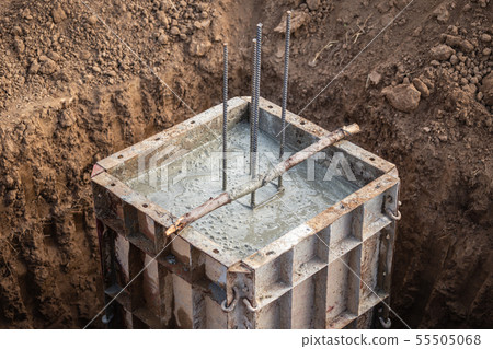 Pouring concrete into steel box for foundation pillar in process of house building Pouring concrete into steel box for foundation pillar in process of house building 55505068
