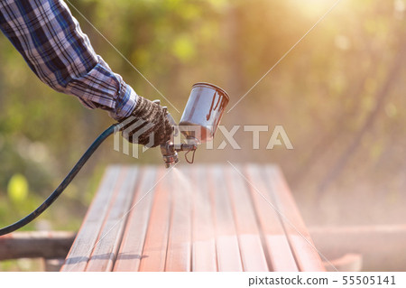 Worker spraying paint to steel pipe to prevent the rust on the surface Worker spraying paint to steel pipe to prevent the rust on the surface 55505141