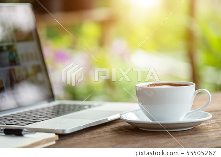 White ceramic coffee cup on wooden table or counter White ceramic coffee cup on wooden table or counter 55505267