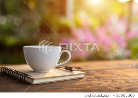 White ceramic coffee cup on wooden table or counter White ceramic coffee cup on wooden table or counter 55505300
