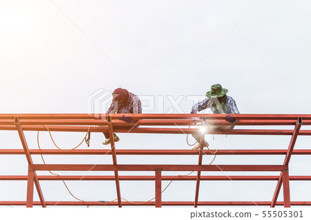 Construction worker welding steel for roof structure Construction worker welding steel for roof structure 55505301