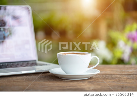 White ceramic coffee cup on wooden table or counter White ceramic coffee cup on wooden table or counter 55505314