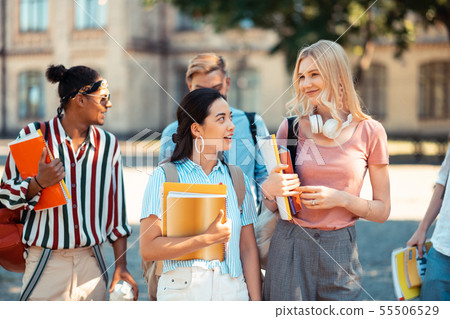 Groupmates talking and joking on their way home. 55506529