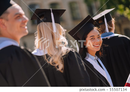 Happy girl smiling to her friend in the crowd. Happy girl smiling to her friend in the crowd. 55507134