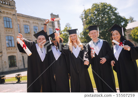 Cheerful students celebrating their graduation from the university. Cheerful students celebrating their graduation from the university. 55507259