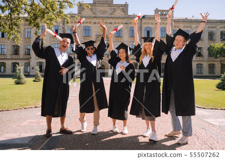 Happy students standing in front of the university. Happy students standing in front of the university. 55507262