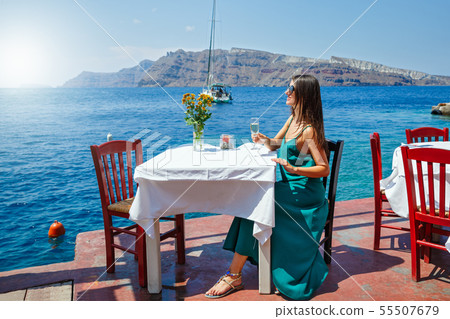 Young woman in a restaurant by the sea 55507679