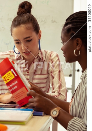 Kind brunette girl staring at her notes Kind brunette girl staring at her notes 55508049
