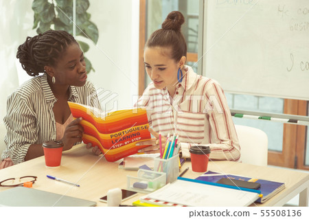 Cheerful brunette woman listening to her tutor 55508136