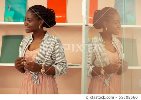 Cheerful young female person presenting her project 55508560