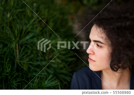 A young businesswoman standing outdoors, relaxing. Copy space. A young businesswoman standing outdoors, relaxing. Copy space. 55508980