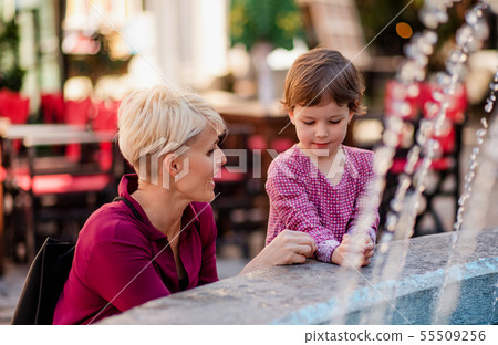 Mother with small daugther having fun outdoors in town. 55509256