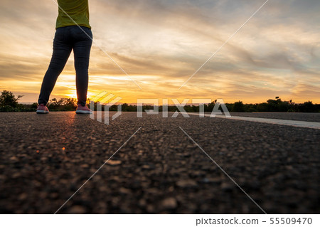 Women wearing t-shirts, jeans, sneakers and hats Women wearing t-shirts, jeans, sneakers and hats 55509470