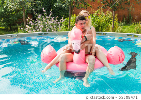 Problem of trash, plastic recycling, pollution and environmental concept - silly man and woman swim Problem of trash, plastic recycling, pollution and environmental concept - silly man and woman swim 55509471