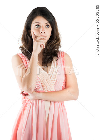 Isolated young woman on a pink dress while on deep thought 55509589