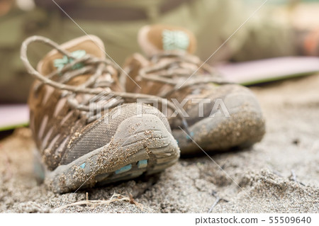 Wet shoes in the sand, blurred background 55509640