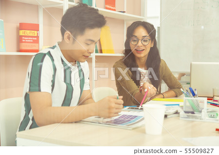 Cheerful brunette female person pointing at text book Cheerful brunette female person pointing at text book 55509827