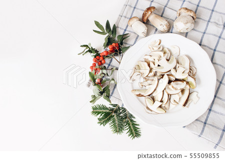 Autumn food arrangement. Composition of whole and sliced porcino mushrooms, ceps on plate. Rowan Autumn food arrangement. Composition of whole and sliced porcino mushrooms, ceps on plate. Rowan 55509855
