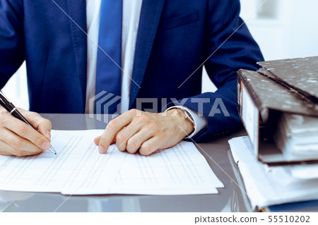 Bookkeeper or financial inspector hands making report, calculating or checking balance. Internal Bookkeeper or financial inspector hands making report, calculating or checking balance. Internal 55510202