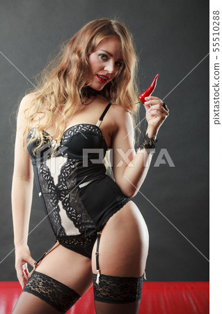 Woman wearing sexy lingerie holding chilli pepper - Stock Photo [55510288] 