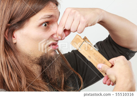 Man with clogged nose by clothespin Man with clogged nose by clothespin 55510316