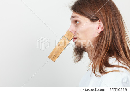 Man with clothespin on nose Man with clothespin on nose 55510319